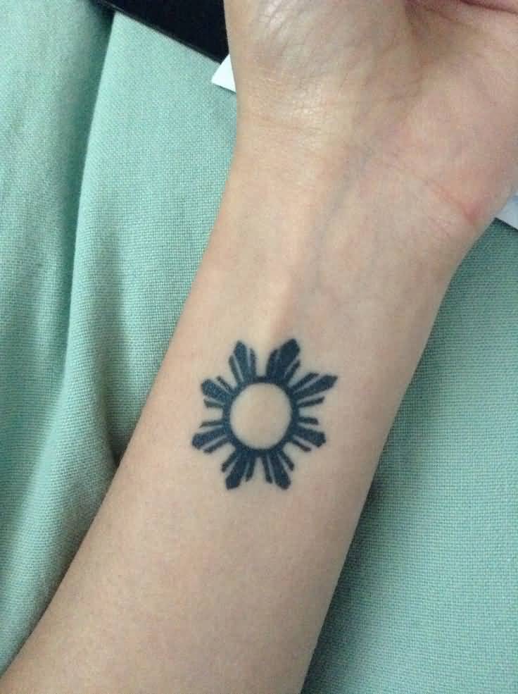 Dark Shade Flapino Small Sun Tattoo On Forearm