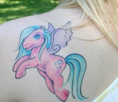 Feminine Pony Tattoo On Girl Back Shoulder