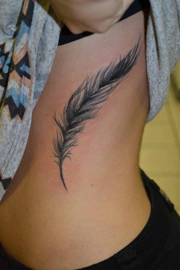 Girl Showing Her Feather Tattoo On Side Rib