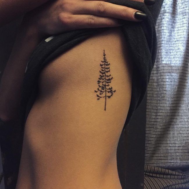 Girl With Pine Tree Tattoo On Side Rib
