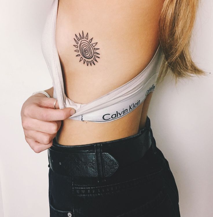 Girl With Simple Sun Tattoo On Side Rib