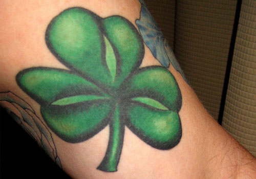 Green And Black Ink Shamrock Tattoo On Bicep