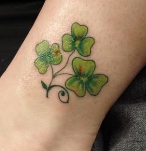 Green Ink Shamrock Tattoo On Leg