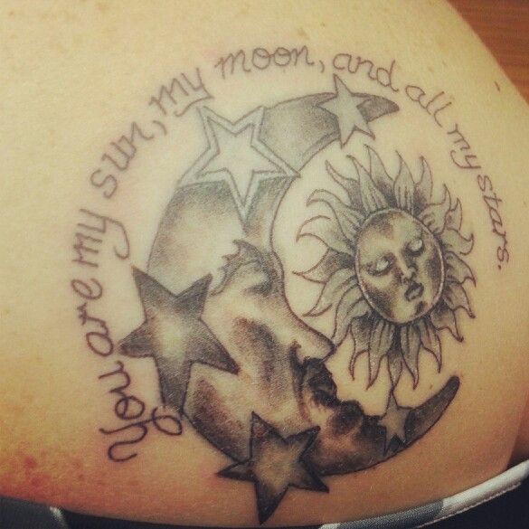 Grey And White Stars With Moon And Sun Tattoo On Lower Back