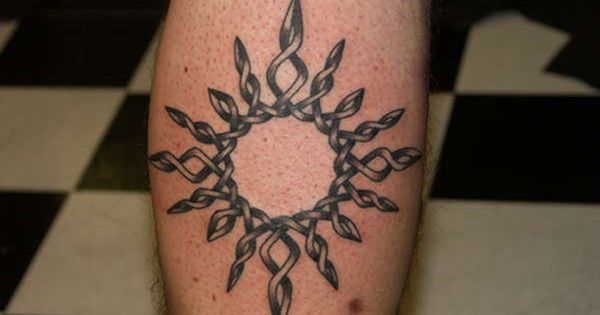 Grey Ink Celtic Sun Tattoo On Back Leg