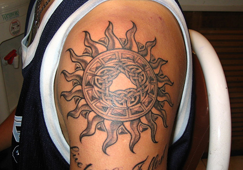 Grey Ink Celtic Sun Tattoo On Shoulder