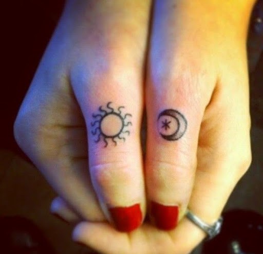 Grey Moon And Sun Tattoos On Both Thumbs
