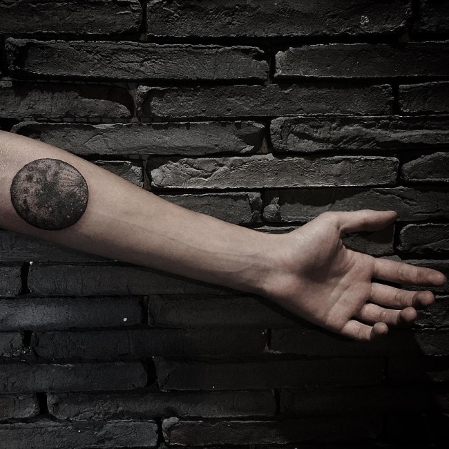 Guy Showing His Full Moon Tattoo On Left Forearm