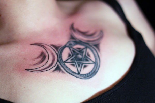 Half Moons And Pentagram Star Tattoo On Chest