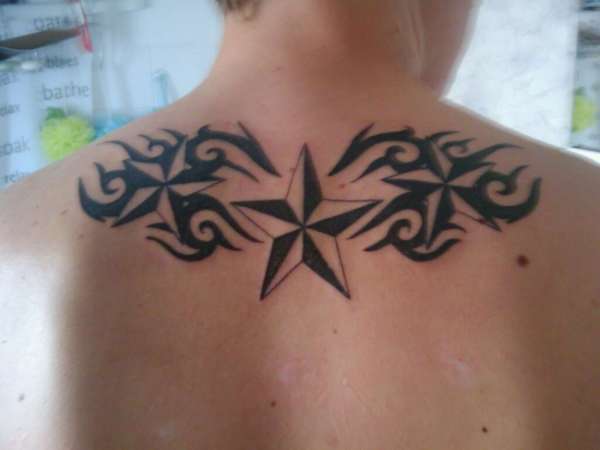 Nautical Stars And Tribal Tattoo On Man Upper Back