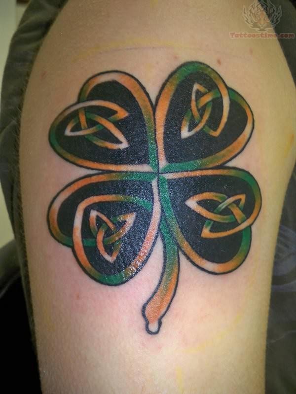 Orangre and Green Celtic Shamrock Tattoo On Shoulder