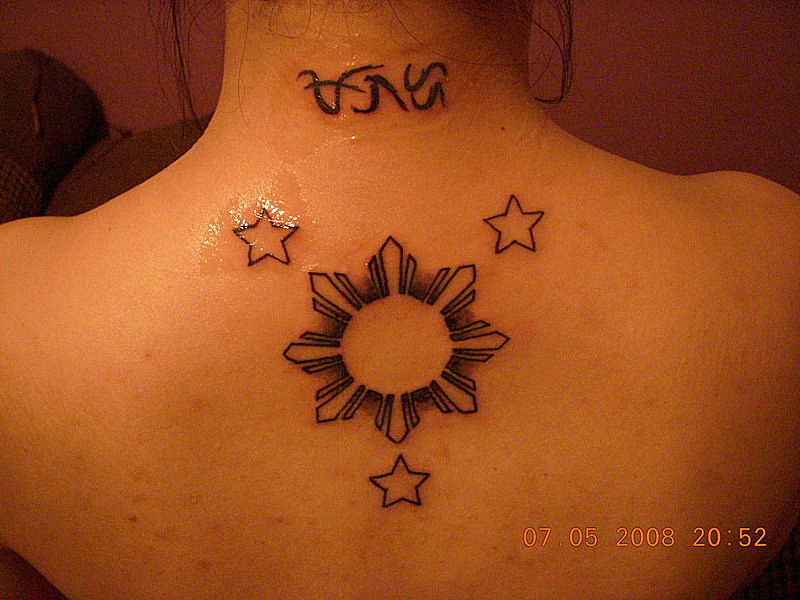 Outline Stars And Sun Tattoo On Upper Back