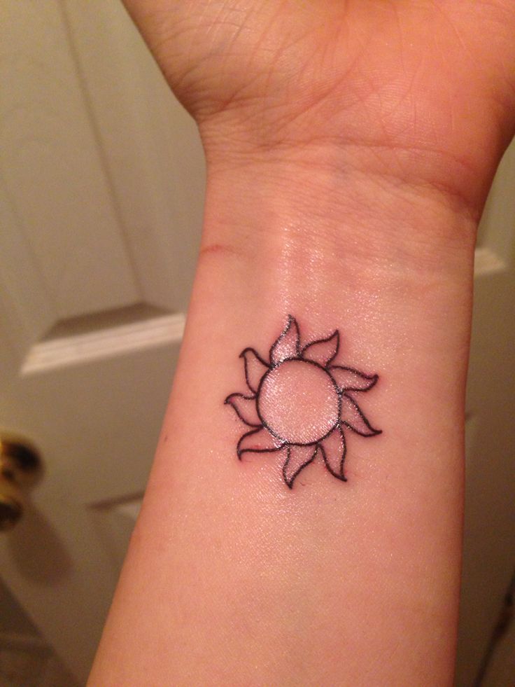 Outline Tribal Sun Tattoo On Left Wrist