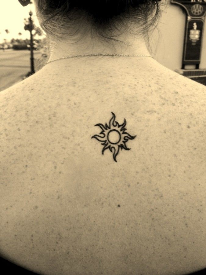 Outline Tribal Sun Tattoo On Upper Back