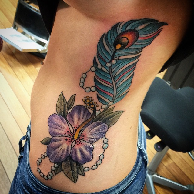 Purple Flower And Peacock Feather Tattoo On Side Rib