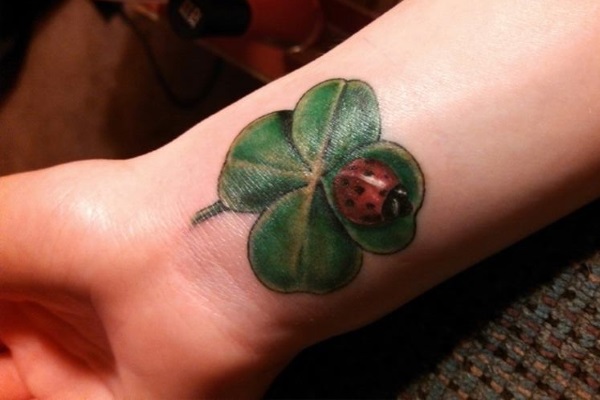 Realistic Bog On Shamrock Leaf Tattoo On Wrist