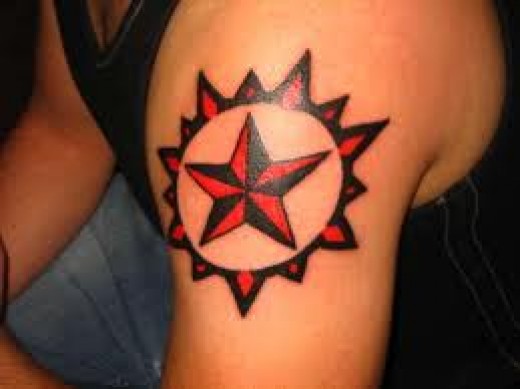 Red And Black Nautical Star Tattoo On Left Shoulder