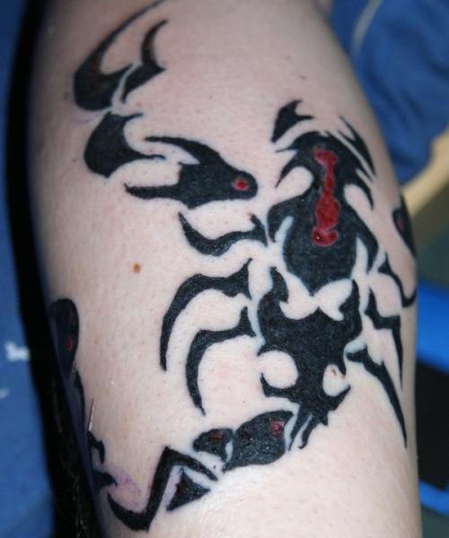 Red And Black Tribal Scorpion Tattoo On Leg