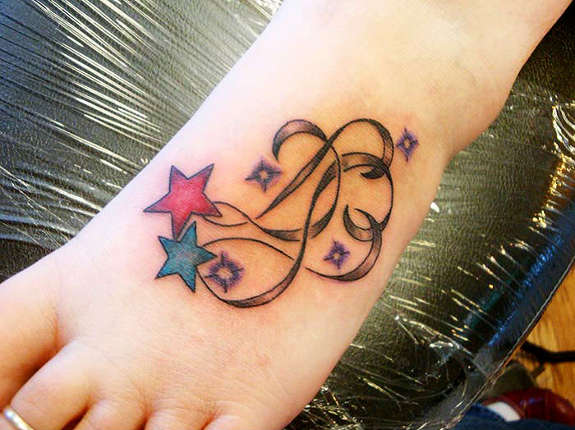 Red And Blue Shooting Stars Tattoo On Left Foot