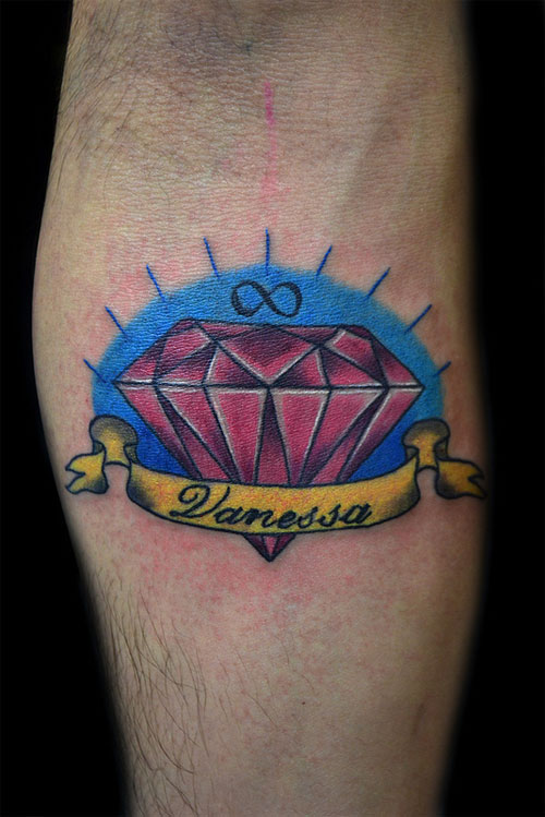 Red Diamond With Vanessa Banner Tattoo On Arm