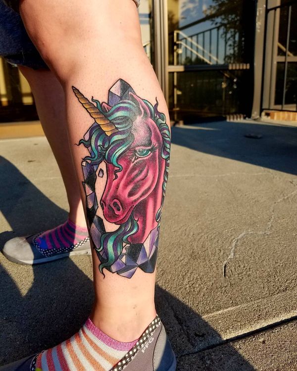 Red Feminine Unicorn Head Tattoo On Left Leg.