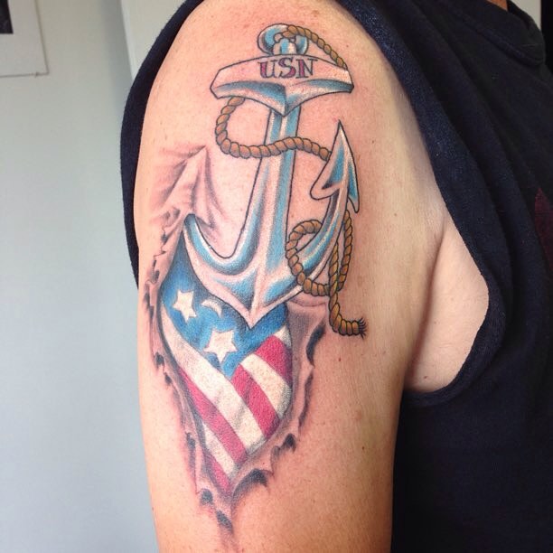 Ripped Skin US Flag And Navy Anchor Tattoo On Shoulder