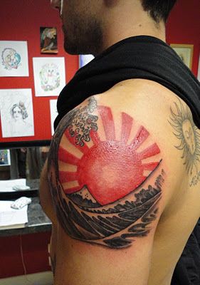 Rising Sun Tattoo On Left Shoulder