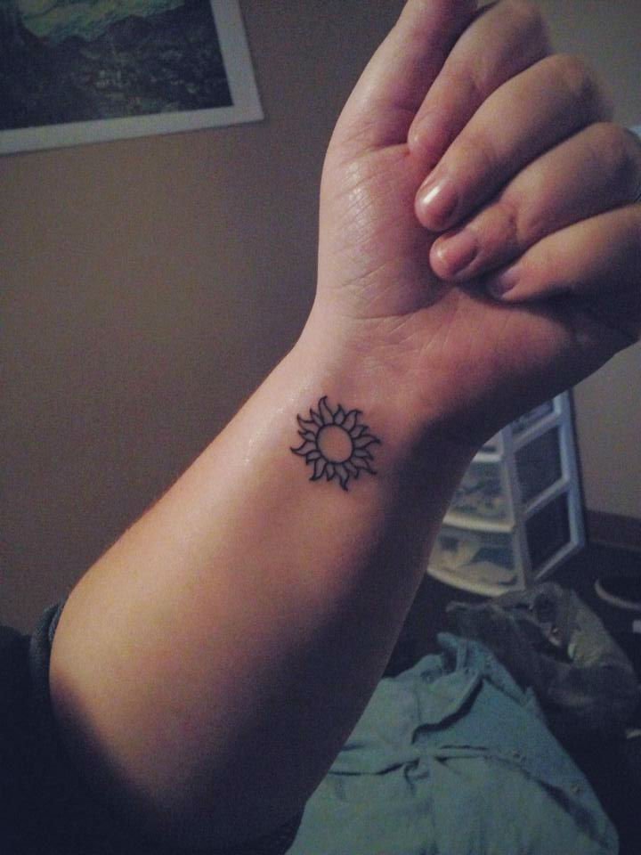 Simple Sun Tattoo On Woman Wrist
