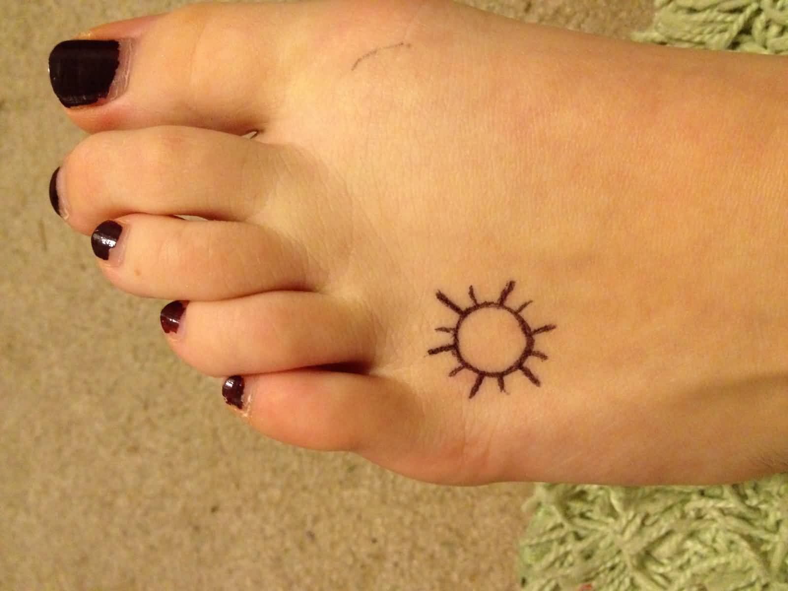 Simple Tiny Sun Tattoo On Girl Left Foot