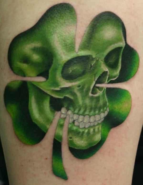 Skull Face In Shamrock Leaf Tattoo On Side Arm