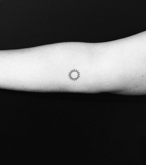 Small Outline Sun Tattoo On Right Forearm