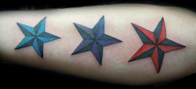 Three Colorful Nautical Star Tattoos On Arm