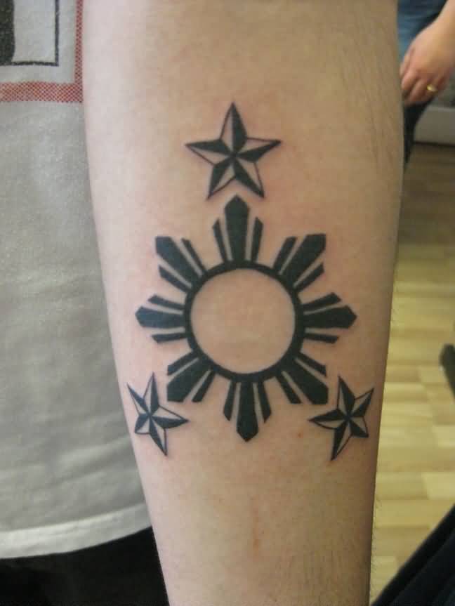 Three Nautical Stars And Sun Tattoo On Left Forearm