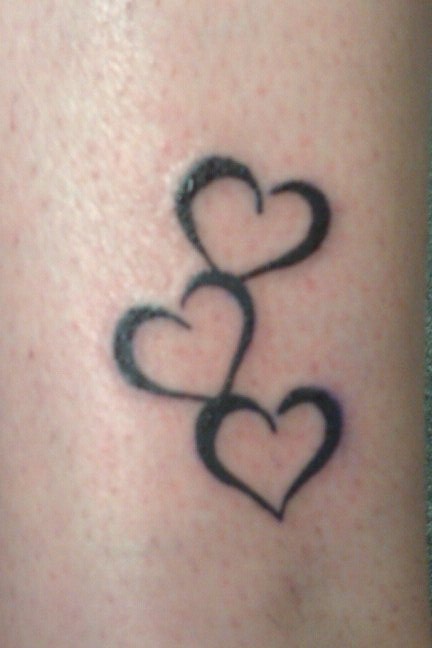Three Black Tribal Heart Tattoos On Arm