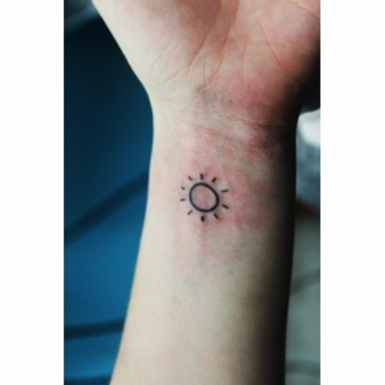 Tiny Sun Tattoo On Left Wrist