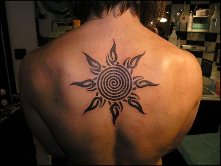 Tribal And Celtic Spiral Sun Tattoo On Upper Back