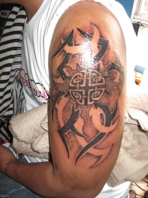 Tribal And Celtic Sun Tattoo On Man Left Half Sleeve