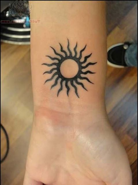 Tribal Simple Sun Tattoo On Left Wrist
