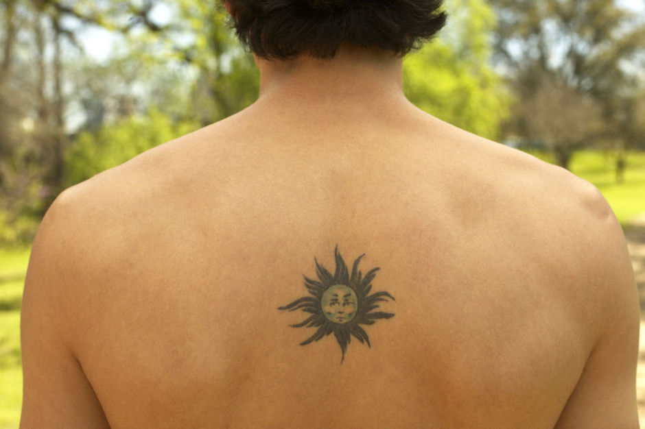 Tribal Small Sun Tattoo On Upper Back