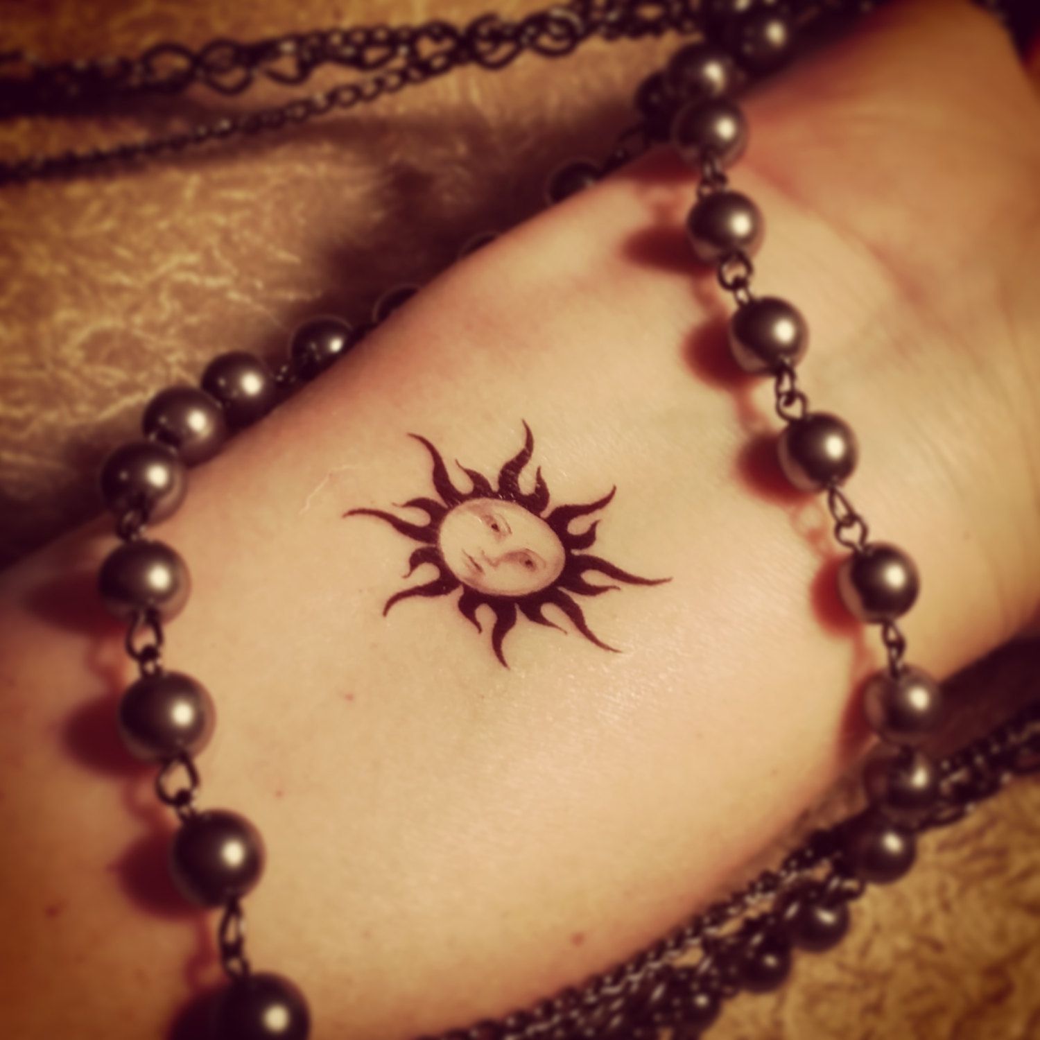 Tribal Small Sun Tattoo On Wrist