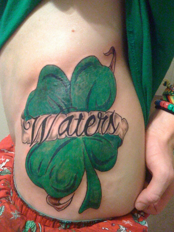 Waters Banner And Shamrock Tattoo On Girl Side Rib