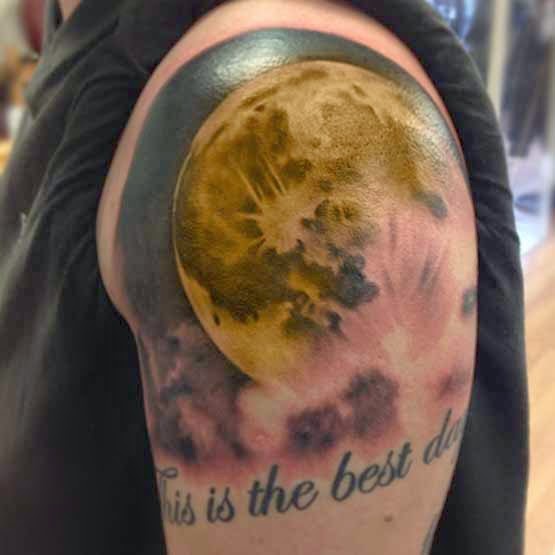 Yellow Full Moon Tattoo On Man Left Shoulder