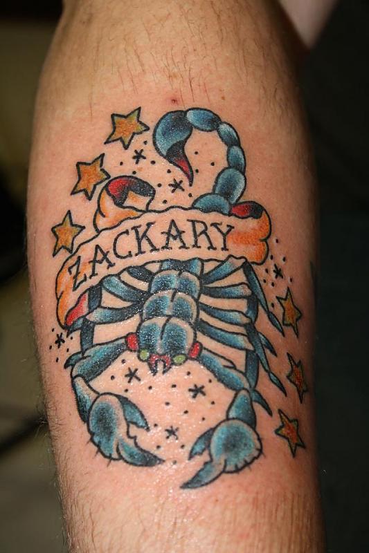 Zackary Banner And Blue Feminine Scorpion Tattoo On Arm