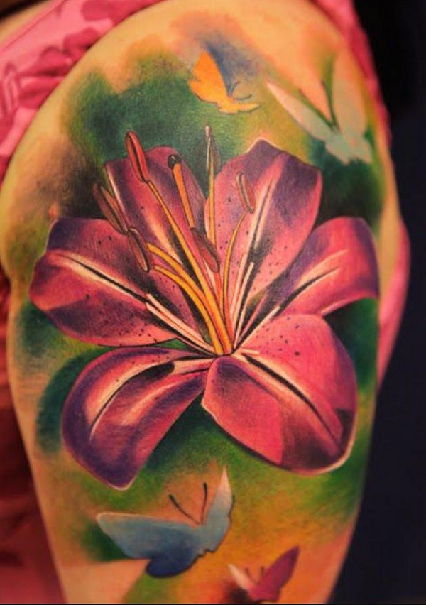 Awesome Colored Lily Flower Tattoo On Girl Left Shoulder