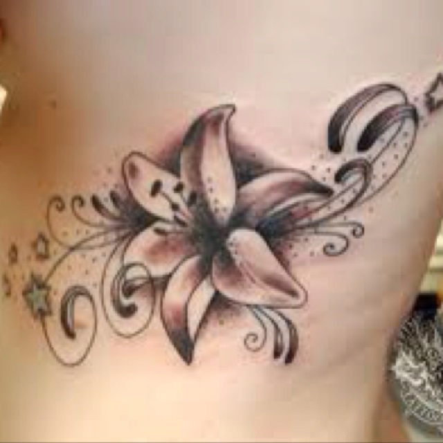 Black And Grey Lily Flower Tattoo On Side Rib