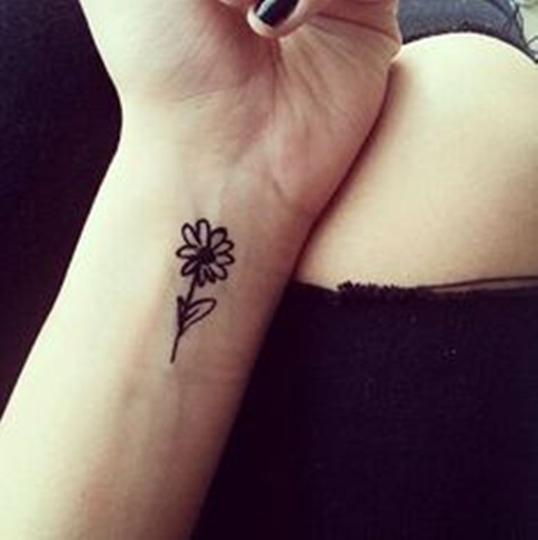 Black And White Small Daisy Tattoo On Girl Left Wrist
