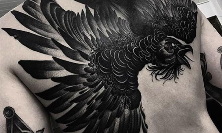 Black Ink Flying Raven Tattoo On Left Back Shoulder