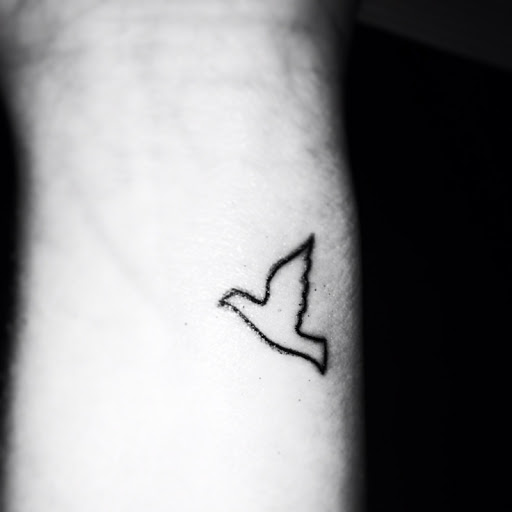 Black Outline Dove Tattoo On Wrist
