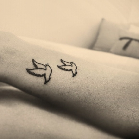 Black Outline Flying Dove Tattoo On Wrist