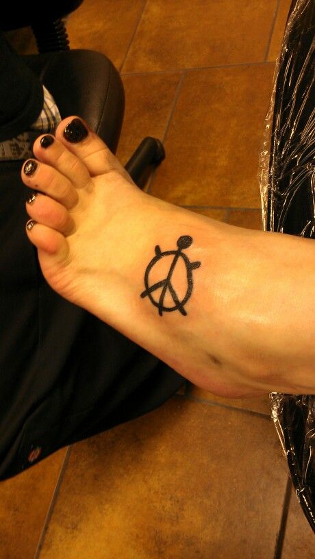 Black Outline Peace Turtle Tattoo On Left Foot
